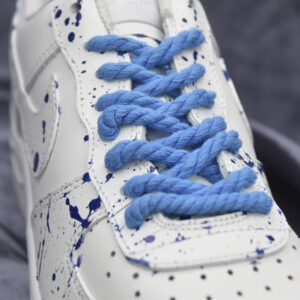 Blue rope laces on a white custom sneaker with blue splatter design